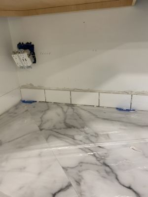start to install first row of subway tile backsplash