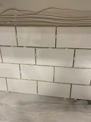 use spacers to make perfect subway tile backsplash grout lines