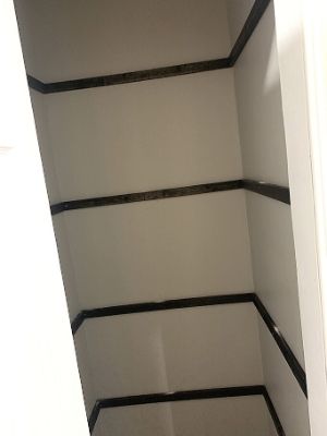 opposite wall of shelf supports