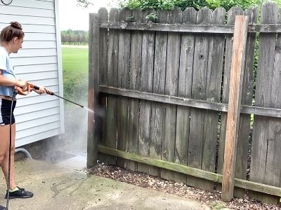 how to clean a wood fence before staining - pressure wash the fence